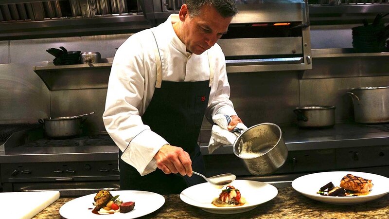 Chef's preparing multiple dishes